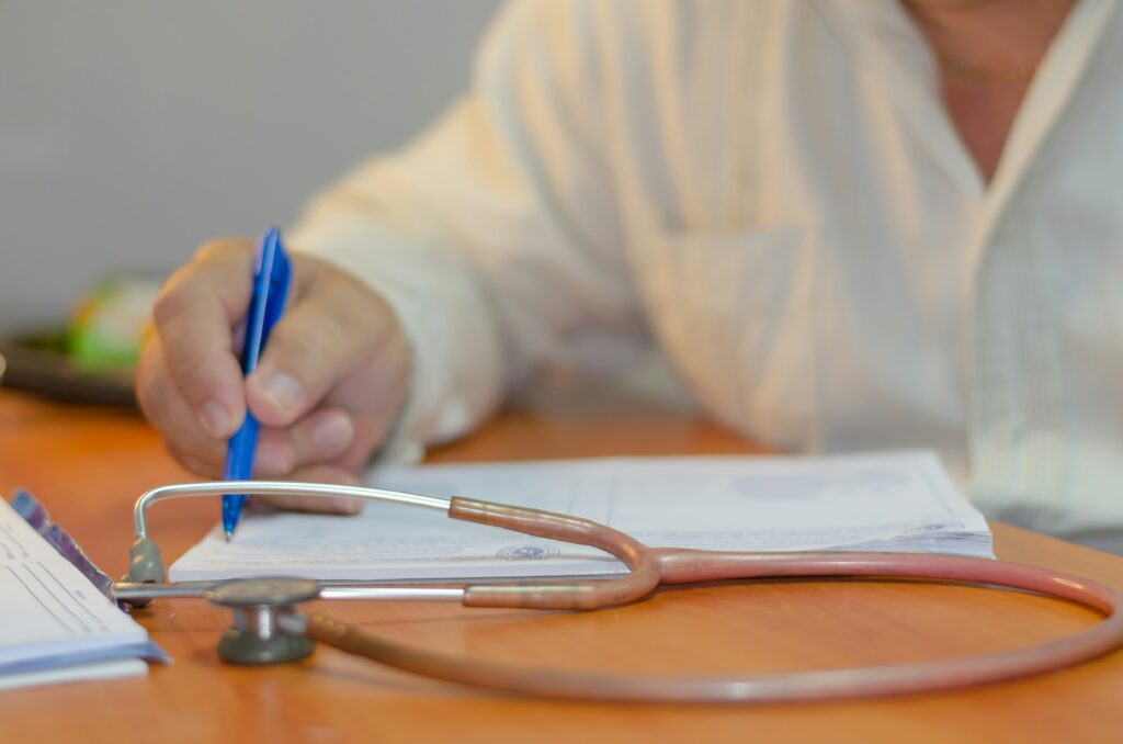 Healthcare provider completing FMLA medical certification form for employee serious health condition leave request